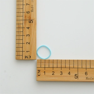 Close-up measurement of a blue high-elastic hair tie showing 2cm diameter on a wooden ruler