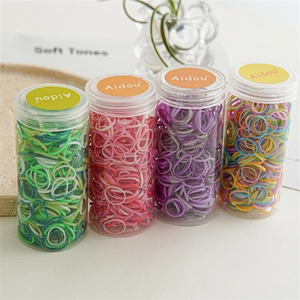 Macro shot of high-elasticity hair ties in four transparent jars for neat hairstyling