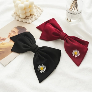 Set of two elegant hair clips with black and burgundy bow ribbons and daisy embroidery