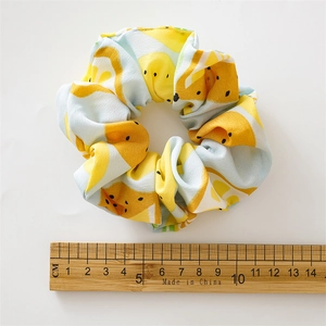 Detail of lemon pattern scrunchie showing approximately 10-11 cm diameter with a ruler