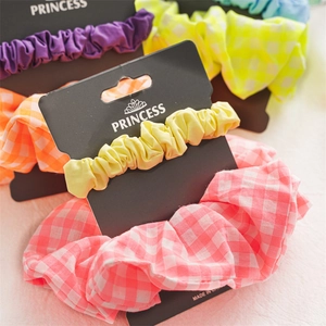 Close-up of vibrant multi-color scrunchies set on display card in high-quality cotton fabric