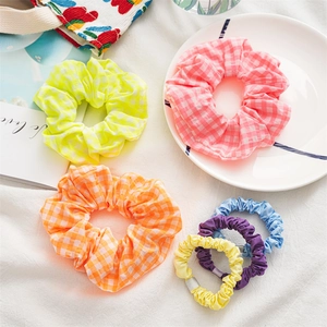 Plaid and solid fabric scrunchies set in vibrant colors for high elasticity hair styling