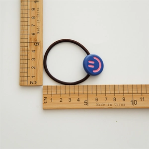 Cute brown elastic hair tie with blue smiley face charm and pink emoji design