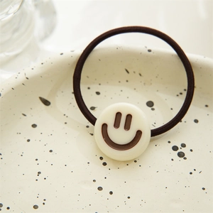 Close-up of high elasticity brown hair tie featuring a cute cream smiley face charm