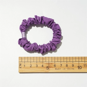 Purple fabric scrunchie with natural folds measuring 8cm in diameter for women styling