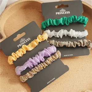 Detailed view of chiffon and linen scrunchies set in pastel colors on display cards