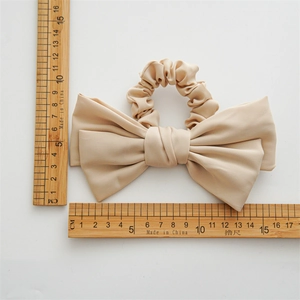 Elegant satin double-layered bow hair scrunchie in beige showing 16cm size scale
