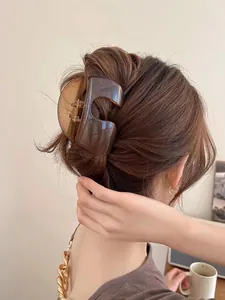 Coffee translucent resin hair claw clip in a geometric hollow design for updos