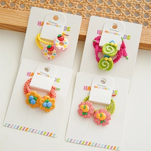 Detailed view of handmade children's elastic hair ties with colorful resin fruit charms