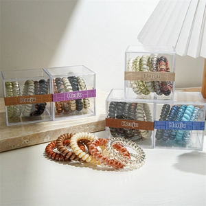 Spiral telephone cord hair ties set in clear boxes with assorted autumn colors
