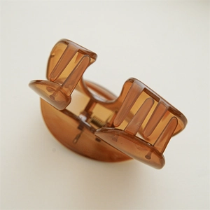 Macro view of large amber brown translucent hair claw clip with strong metal spring