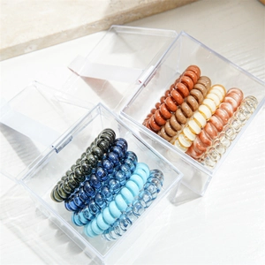 Close-up of spiral telephone wire hair ties in multi-color sets with clear box
