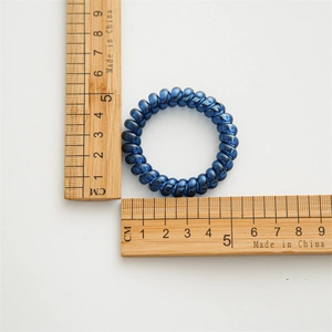 Dark blue metallic spiral hair tie with 4.5cm diameter measurement on white background
