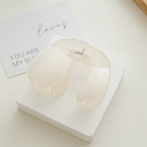 Detail view of large cream horseshoe hair claw clip with sturdy metal spring mechanism