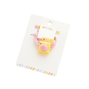 Cute pink elastic hair tie with yellow biscuit charm and peach detail on white card