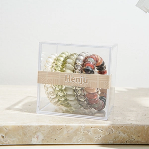 Detail view of 5-piece spiral phone cord hair ties set in a transparent acrylic gift box