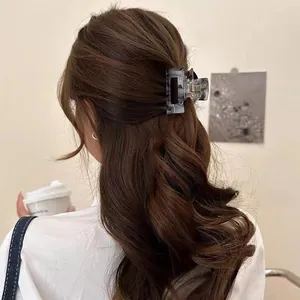Detail of gray marble acetate rectangular hair claw clip on half-up hairstyle