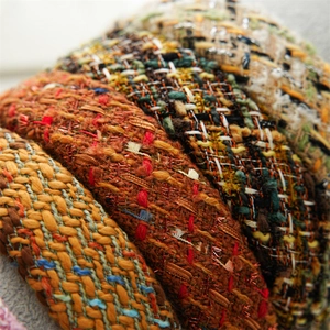 Macro view showing the rich tweed fabric texture and woven patterns of multiple headbands