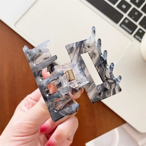 Elegant rectangle acetate hair claw with grey marble texture for a stylish look