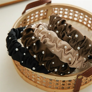 Satin pleated headbands with pearl accents in black, coffee, beige, and brown colors