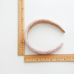 Pink tweed padded headband with vintage woven texture for an elegant hair accessory style