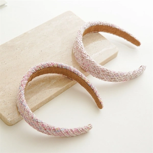 Detail of pink tweed padded headband with thick woven texture and brown velvet inner lining