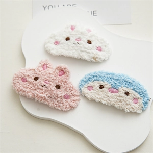 Close-up of cute cartoon animal plush hair clips in rabbit, bear and penguin shapes