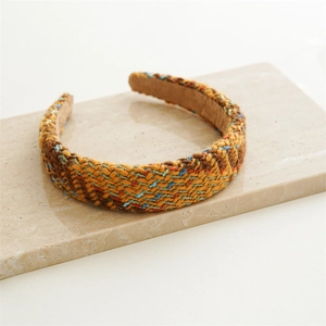 Detail of multi-color woven tweed headband with retro ethnic patterns and soft velvet lining