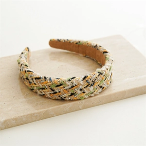 Macro shot of tweed headband texture with woven silver threads and soft brown suede lining