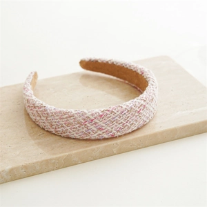 Detailed texture of pink and white tweed headband with soft brown velvet lining