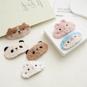 Close-up of cute plush animal hair clips including bunnies and bears with embroidery
