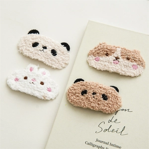Set of four cute plush animal hair clips including panda and rabbit designs in soft white