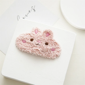 Close-up of pink plush bunny hair clip with lamb wool texture and fine embroidery