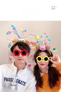 Detail of plush cartoon monster headband featuring colorful spiral antennas and fuzzy pom-poms