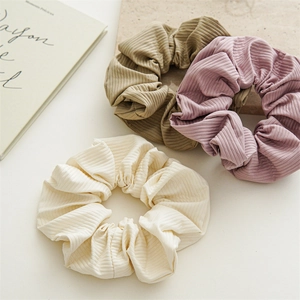 Three-piece set of elegant nylon scrunchies in cream, khaki, and soft purple tones