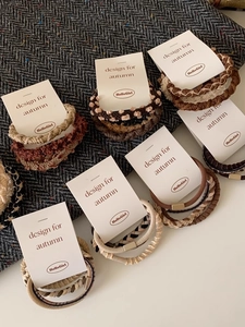 Close-up of autumn-style braided hair ties and plush scrunchies in coffee tones