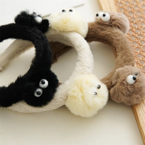 Bandeaux pelucheux monstre en noir, beige et marron avec de grands yeux de dessin animé