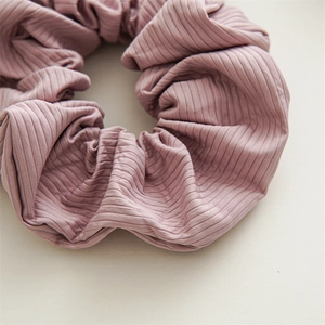 Detail shot of Morandi pink scrunchie showing soft ribbed knit texture and premium stitching