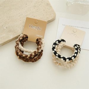 Detail of coffee-colored braided hair ties set with high elasticity on display card