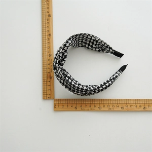 Flat lay of houndstooth knot headband with wooden ruler showing dimensions 12.5cm