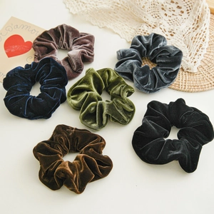Elegant velvet hair scrunchies in six colors arranged on a rustic lace background