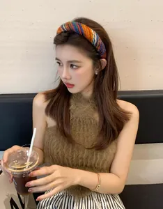 Detailed view of a multi-color chunky knit headband featuring ethnic weaving patterns