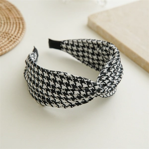 Detail of classic houndstooth headband showing the textured fabric and top twist knot design
