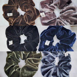Detail view of 6-piece velvet scrunchie set with handmade labels in diverse colors