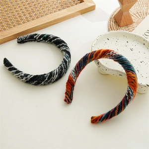Detail of handmade knitted headbands featuring colorful wool textures and inner label