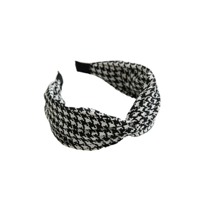 Elegant wide knotted headband for women featuring a classic black and white houndstooth pattern