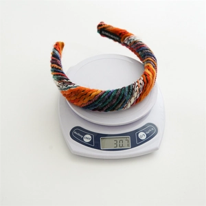 Retro multi-colored woven knit headband for women weighing approximately 30.7g on scale