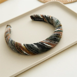 Detail of colorful knitted headband featuring chunky yarn and handmade label tag