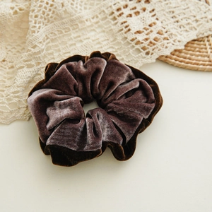 Detailed close-up of dark brown velvet scrunchie showing plush texture and soft sheen