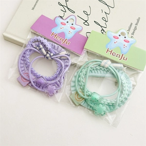 Detail of candy-colored hair scrunchies with floral charms and bow tie ornaments